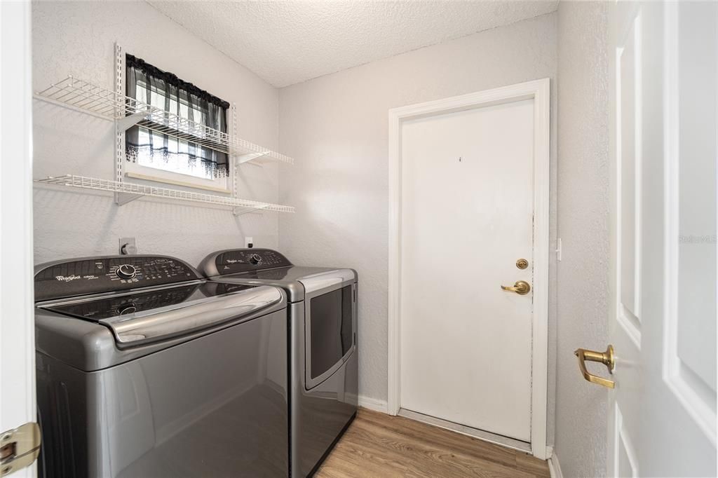 Indoor laundry room with door to garage