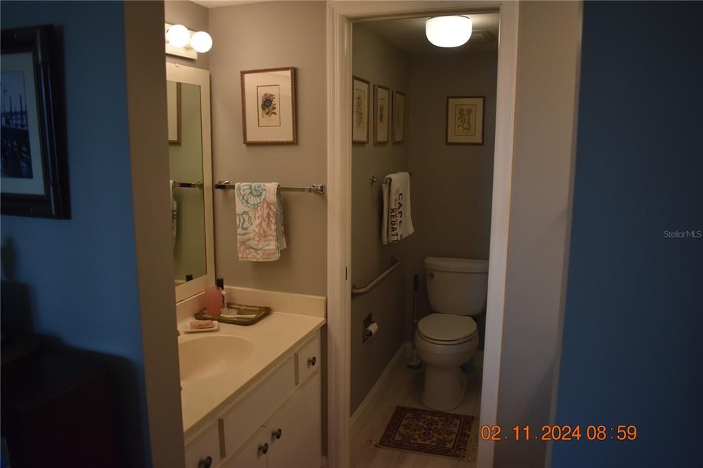 Main bathroom with double split side vanities.