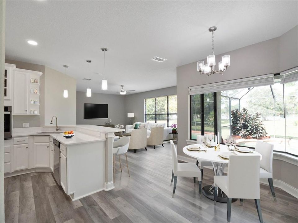 Light and bright kitchen has casual dining space & is open to the family room. Virtually Staged.