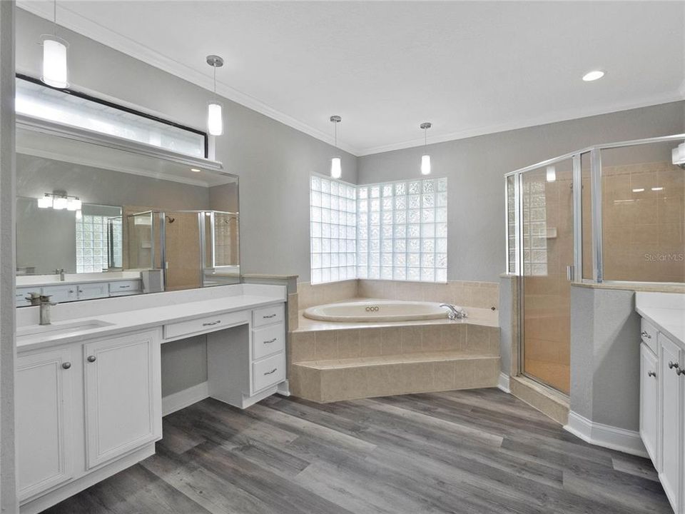 The owner’s suite also gives the homeowner direct access to the lanai and pool via sliding glass doors, DUAL WALK-IN CLOSETS and a well appointed en-suite complete with dual/split vanities and a whirlpool tub.