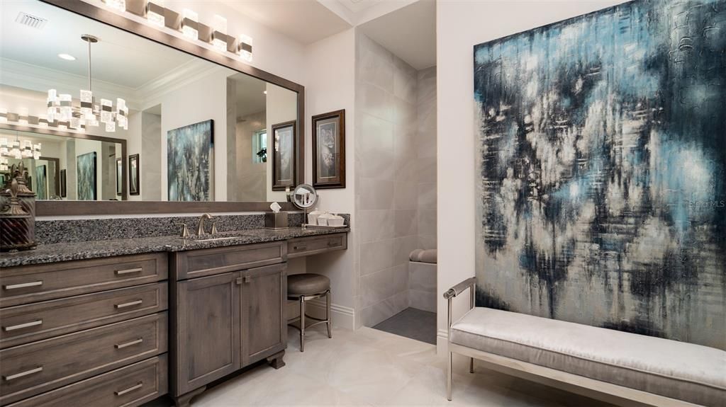 Handsome cabinetry and countertops. Dual showers behind the center wall.