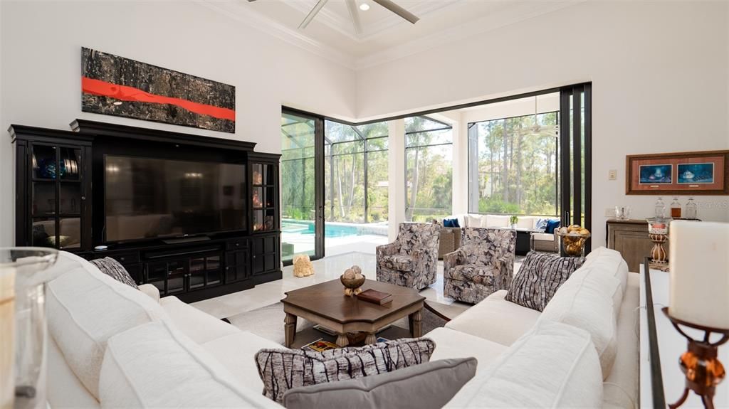 Great room looking towards the fully opened sliding doors to pool and lanai.