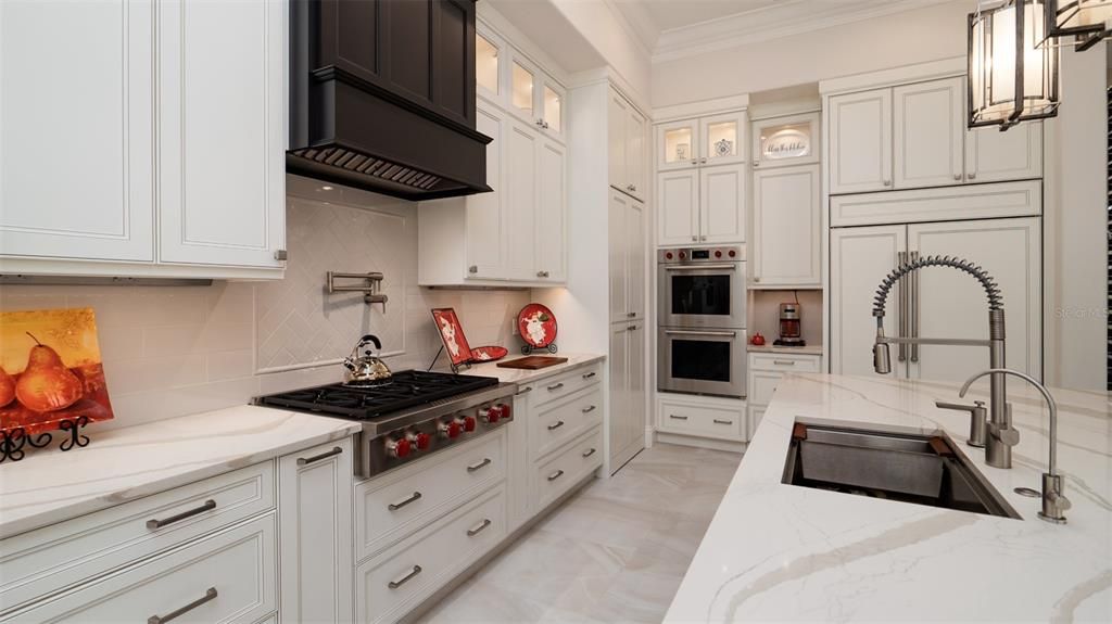 Double ovens, 6-Burner Gas Stove, Sub-Zero Refrigerator and stylish vent hood.