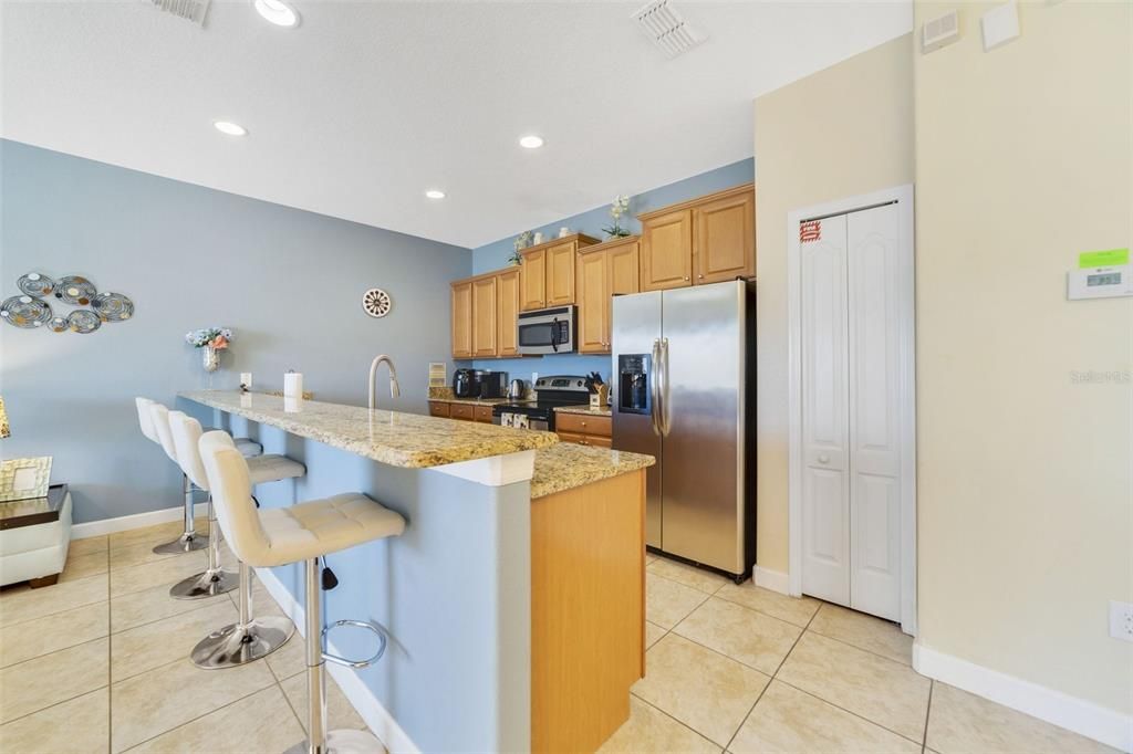 Enjoy cooking at home? You will delight in the spacious kitchen complete with STAINLESS STEEL APPLIANCES, ample storage, GRANITE COUNTERS and there is bar seating on the peninsula for additional casual dining or perfect for entertaining.