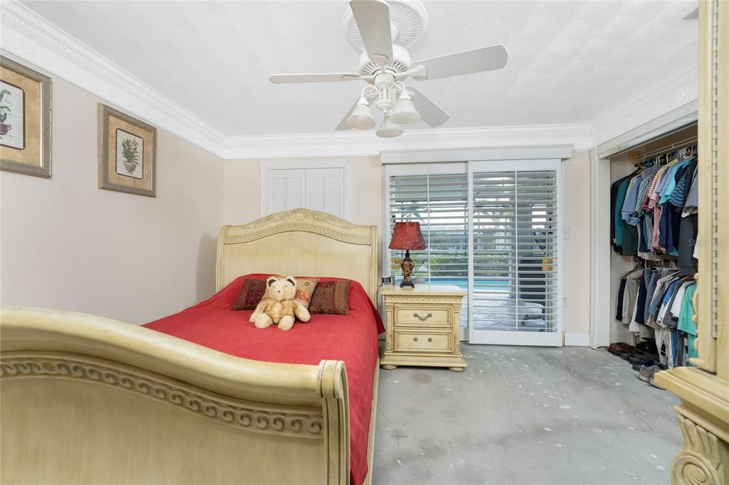 Primary bedroom needs new flooring - plantation shutters adorm the sliders to the lanai