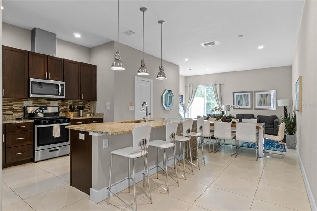 A ton of room for dining and entertaining in this open floor plan with tiled floors in the main living areas