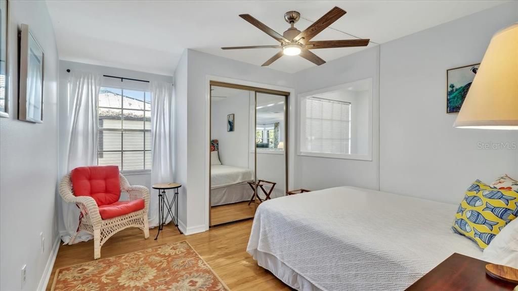 Second bedroom with oak hardwood flooring and new ceiling fan.