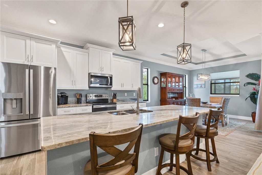 At the heart of the home is a well-equipped kitchen featuring beautiful granite countertops and 48" cabinetry.