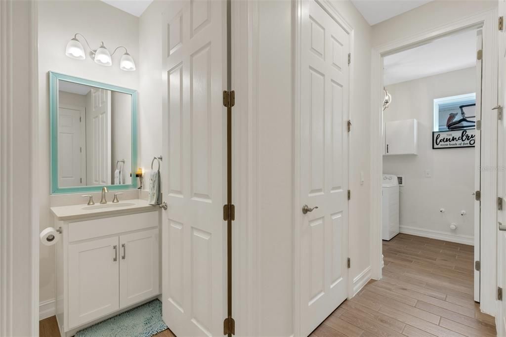 View of hall powder room and utility room