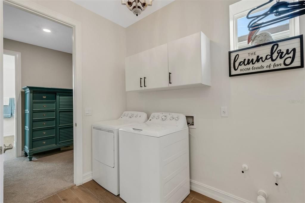 Utility room accessible from primary bedroom closet