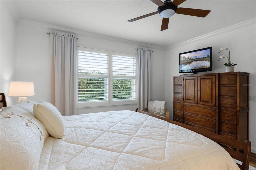 Primary Bedroom features a Large Walk-in Closet with Custom Closet Organizer System