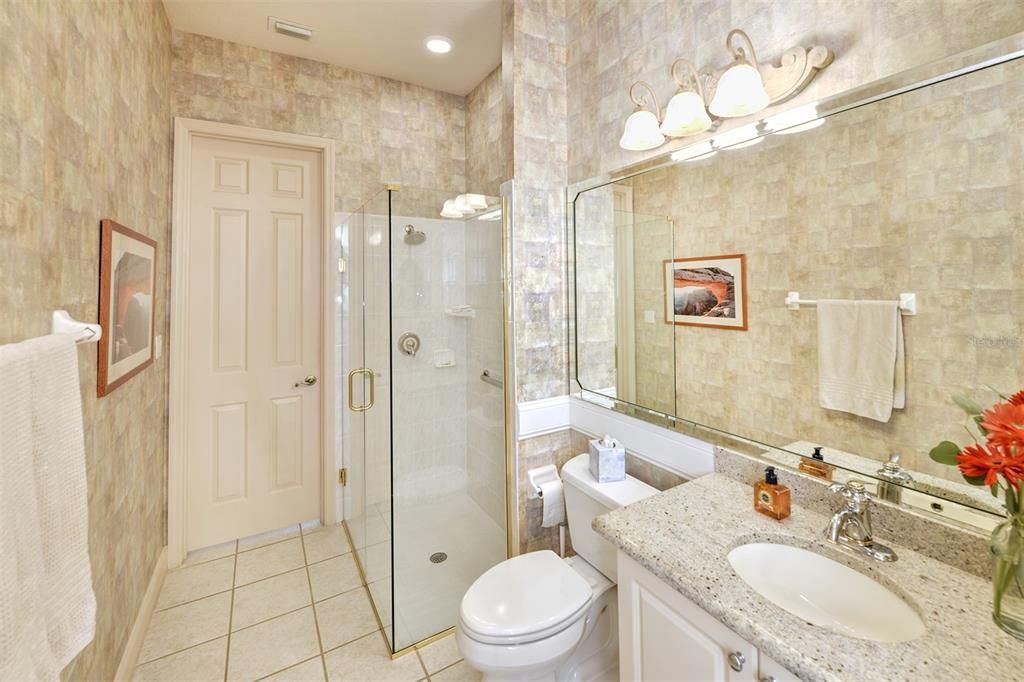 2nd primary bath with walk-in shower and granite vanity.