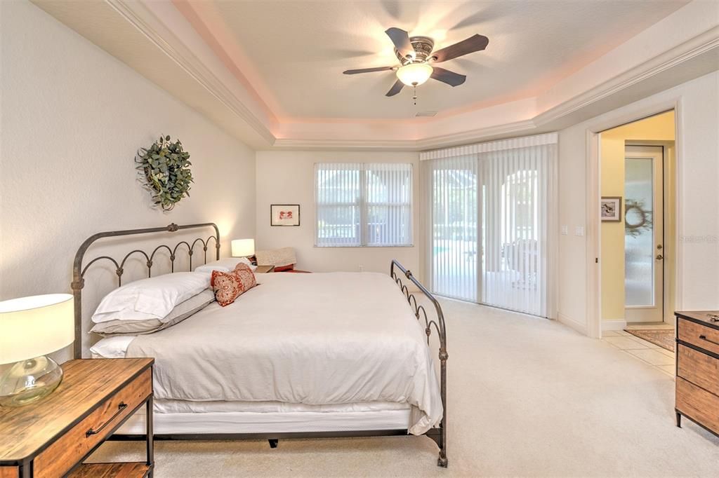 Primary suite with sliders to the lanai and pool.