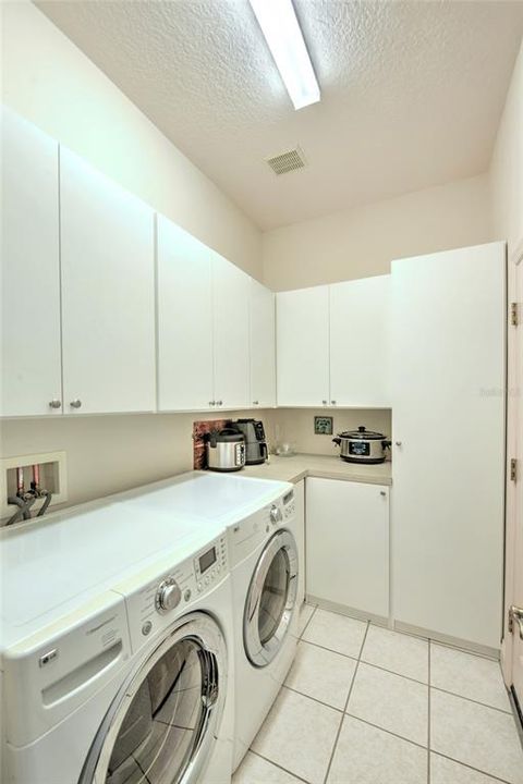 Utility room with an abundance of storage.