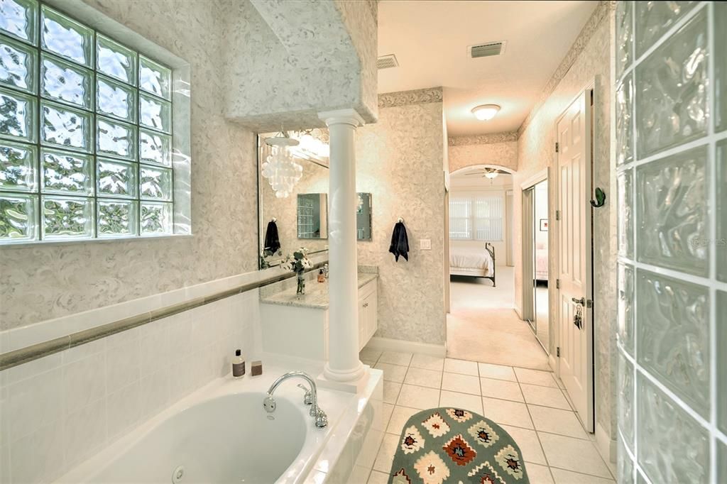 Primary bath with jetted tub, walk-in shower and double granite vanities.