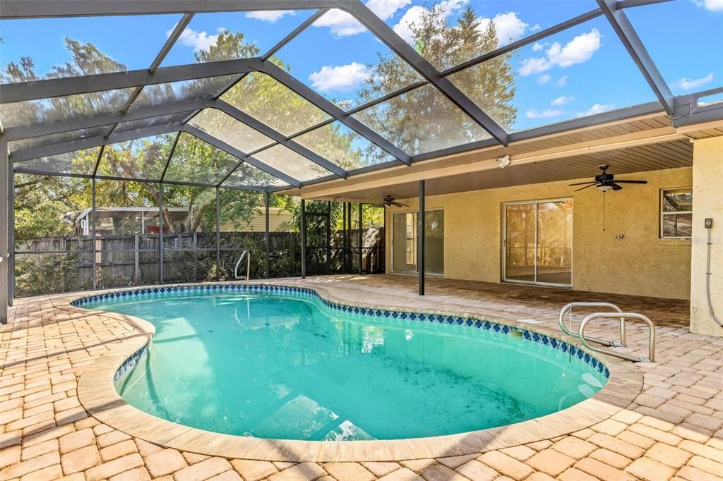 Pool with covered space, pavers, screened lanai