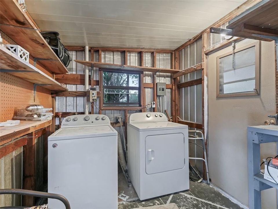 Laundry and utility room with golf cart