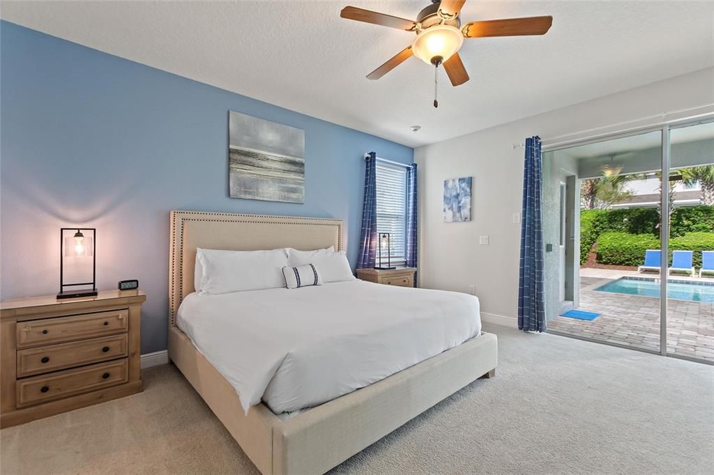 A downstairs bedroom with a beautiful view of the pool. (17' x 15')