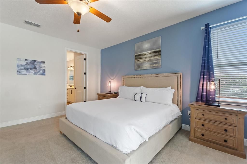 Another view of the first floor bedroom with a pool view seeing the ensuite bathroom.