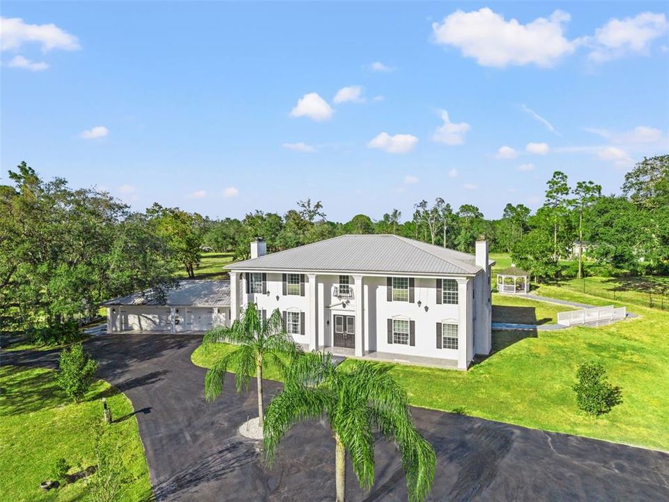 Colonial-inspired estate, designed with the grandeur reminiscent of the iconic “White House.” Set on a private 2.40-acre property