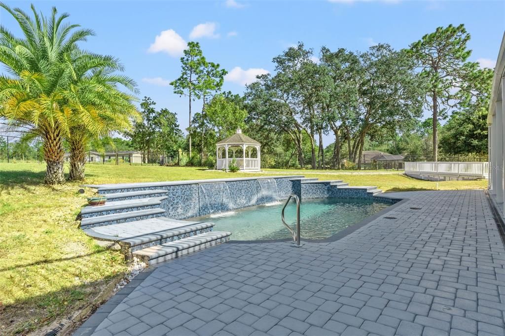 Heated Pentair pool with a tranquil waterfall