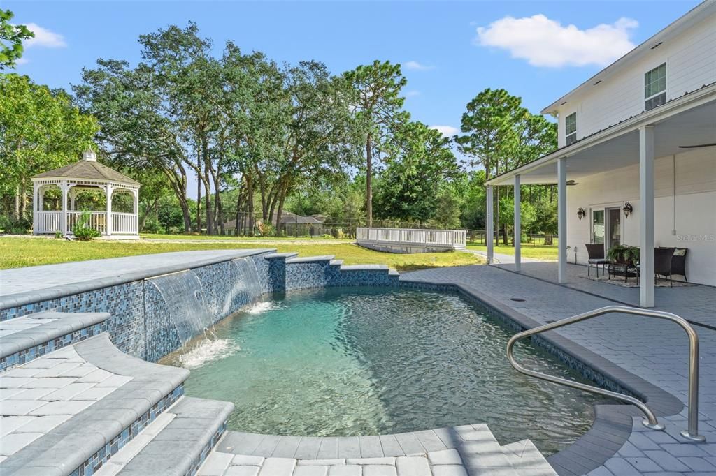 Heated Pentair pool with a tranquil waterfall