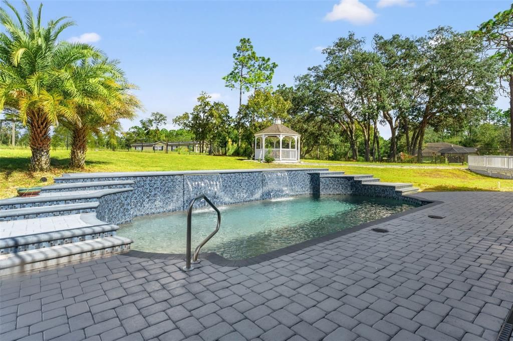 Heated Pentair pool with a tranquil waterfall