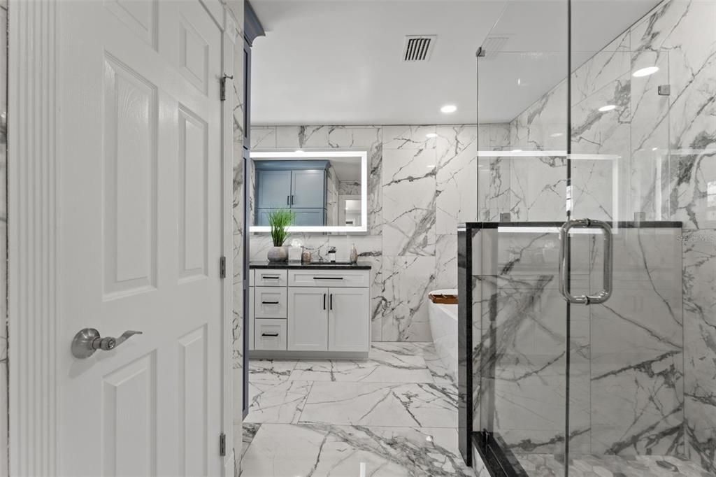 Spa-Like Master Ensuite with Dual Vanities, a Rainfall Shower, and a Garden Tub.