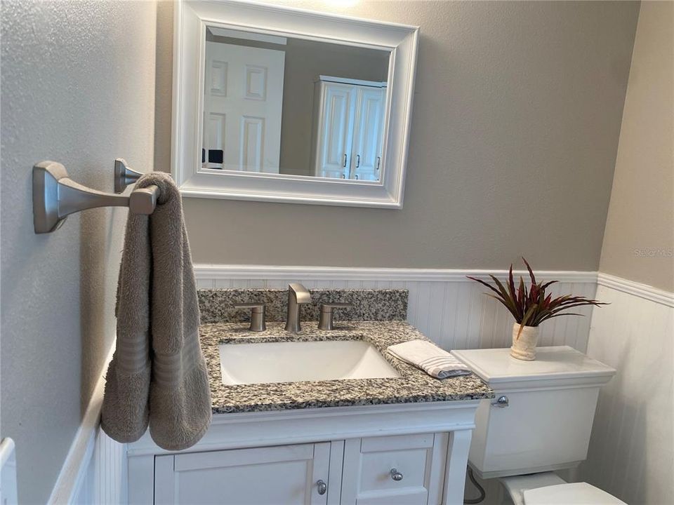 The downstairs half bath and it leads to the lanai and pool area.