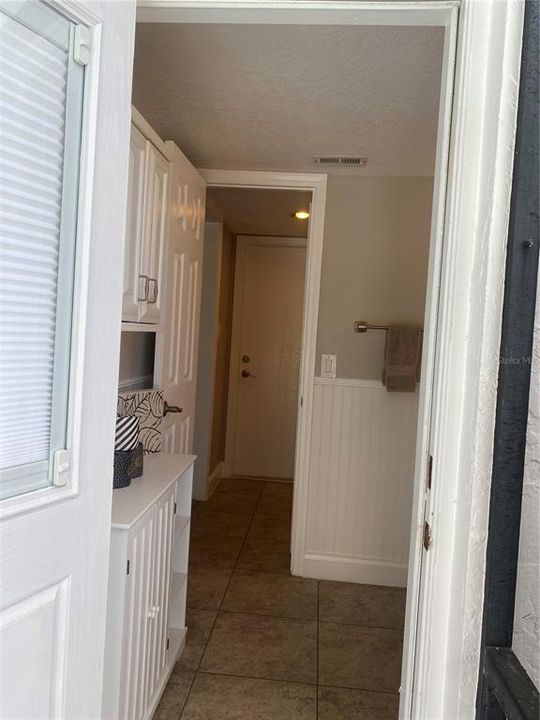 Entering the house from the pool. The laundry is situated next to the bath.