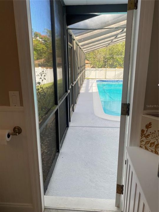 View to pool and lanai from the half bath.