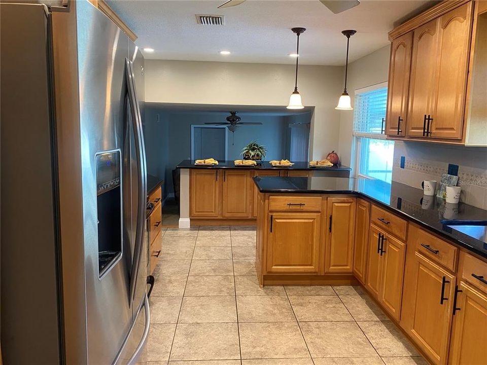 From the dining room the kitchen is adorned with wood cabinets, stainless appliances and granite counter tops.