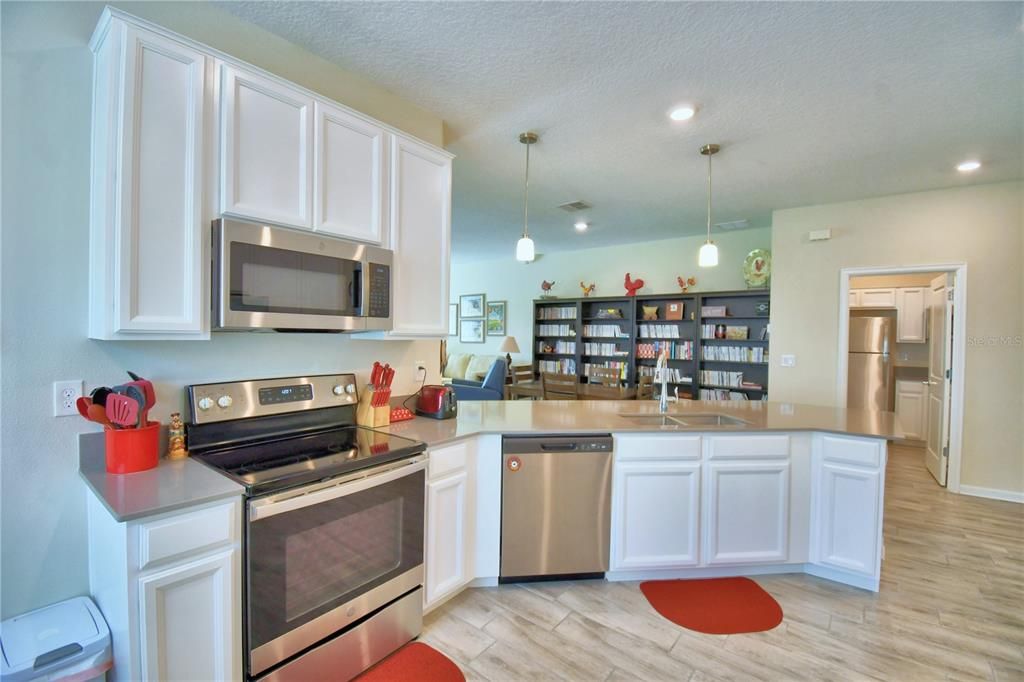 Glass top range with microwave hood. Easy to work in kitchen keeps you in contact with everyone else.