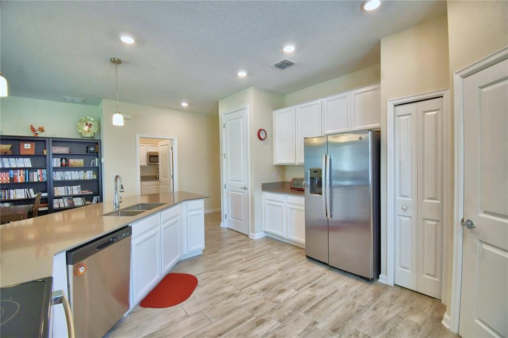 Other side of the kitchen with more workspace and storage including a pantry