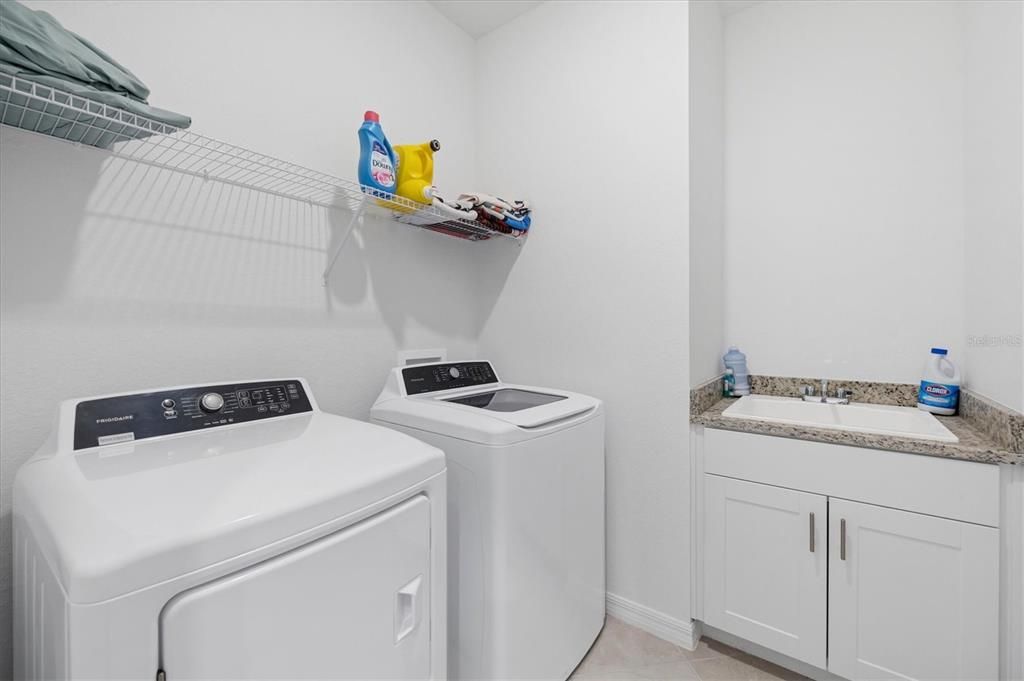 full laundry room including utility sink