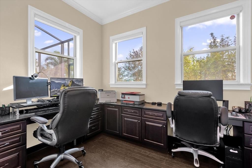 Office with built in desks and motorized blinds