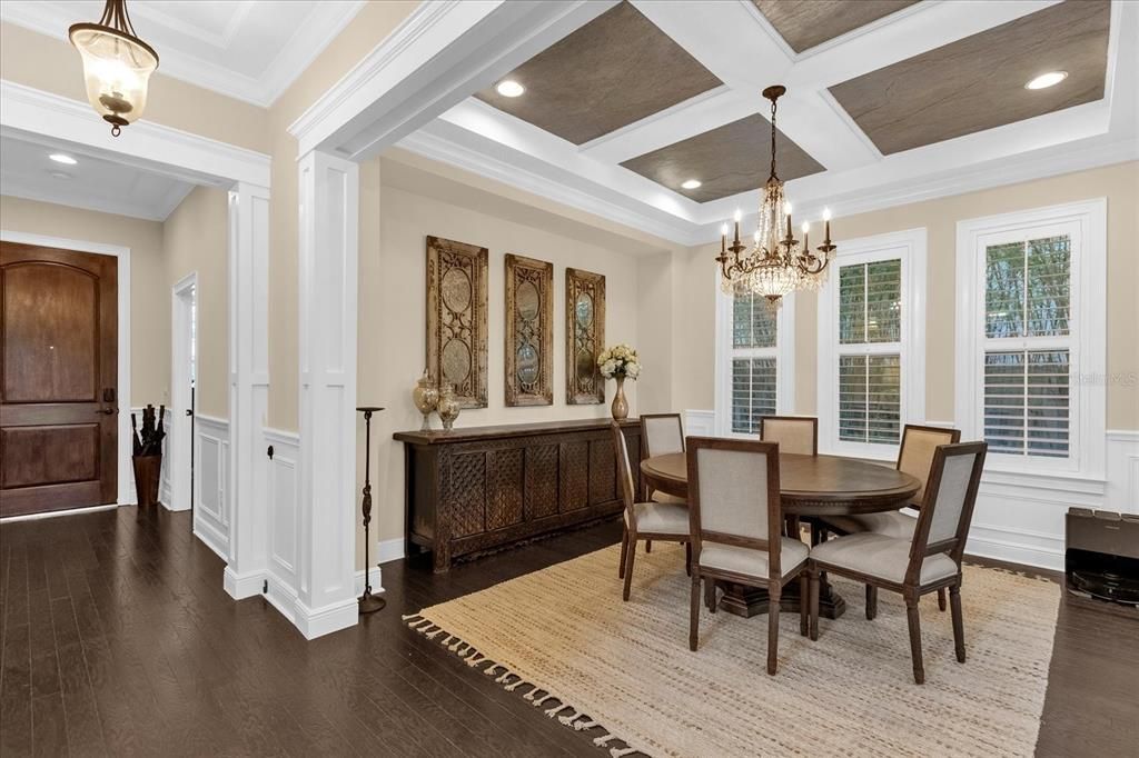 Entryway and formal dining room with stone tray ceilings