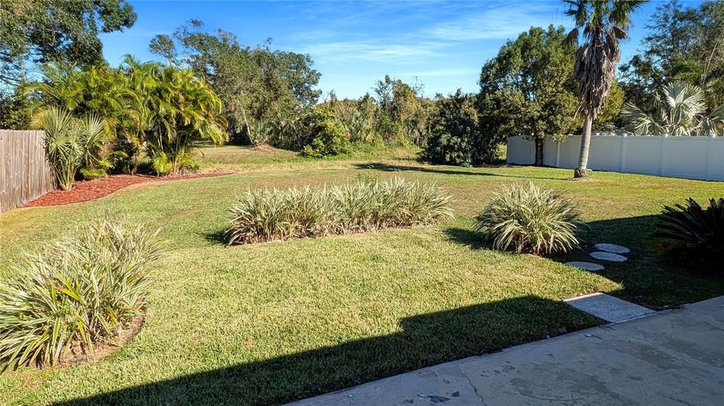 Large SCREENED PORCH and Extensive Bonus Concrete Patio all along the Rear of the Home Overlooks BIG, BACKYARD with Landscaping giving Pets and Kids Lots of Room to Run!