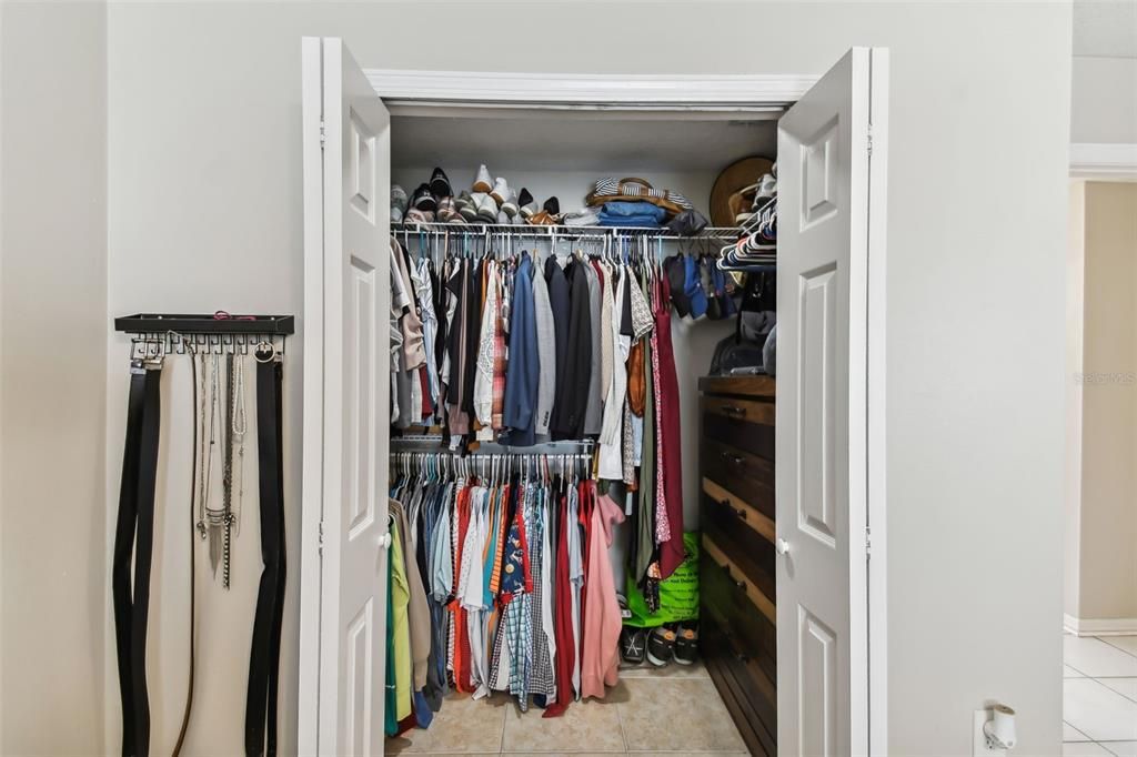 Walk-in closet has plenty of room for clothing and space for a dresser