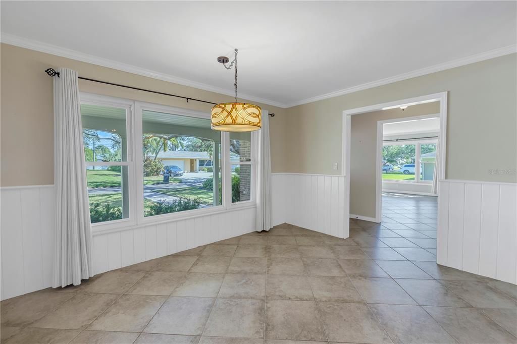 The dining room features a large picture window with beautiful views of the landscaped yard.