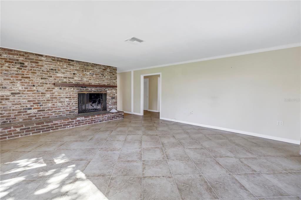 Expansive living room with a wood-burning fireplace.