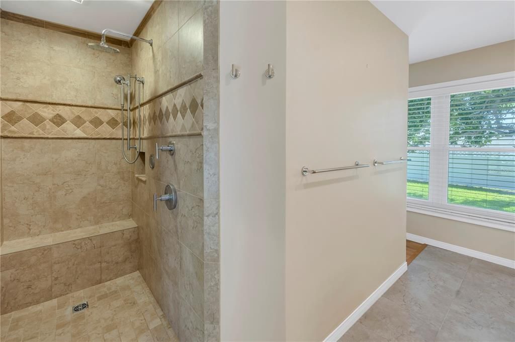 Primary walk-in shower and built in bench.