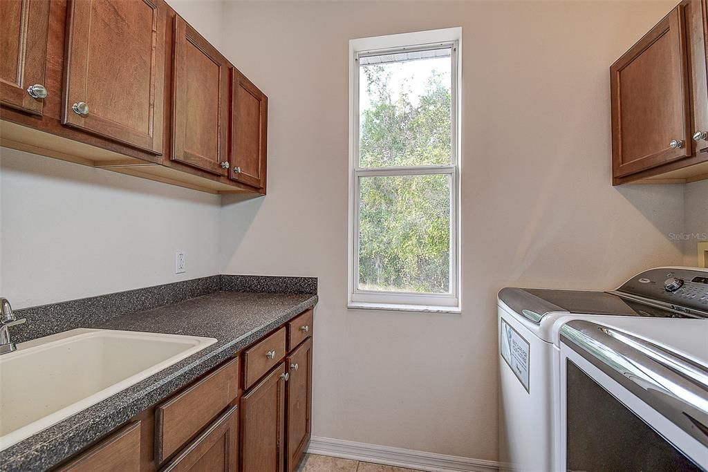 Inside Laundry with plenty of wood cabinets