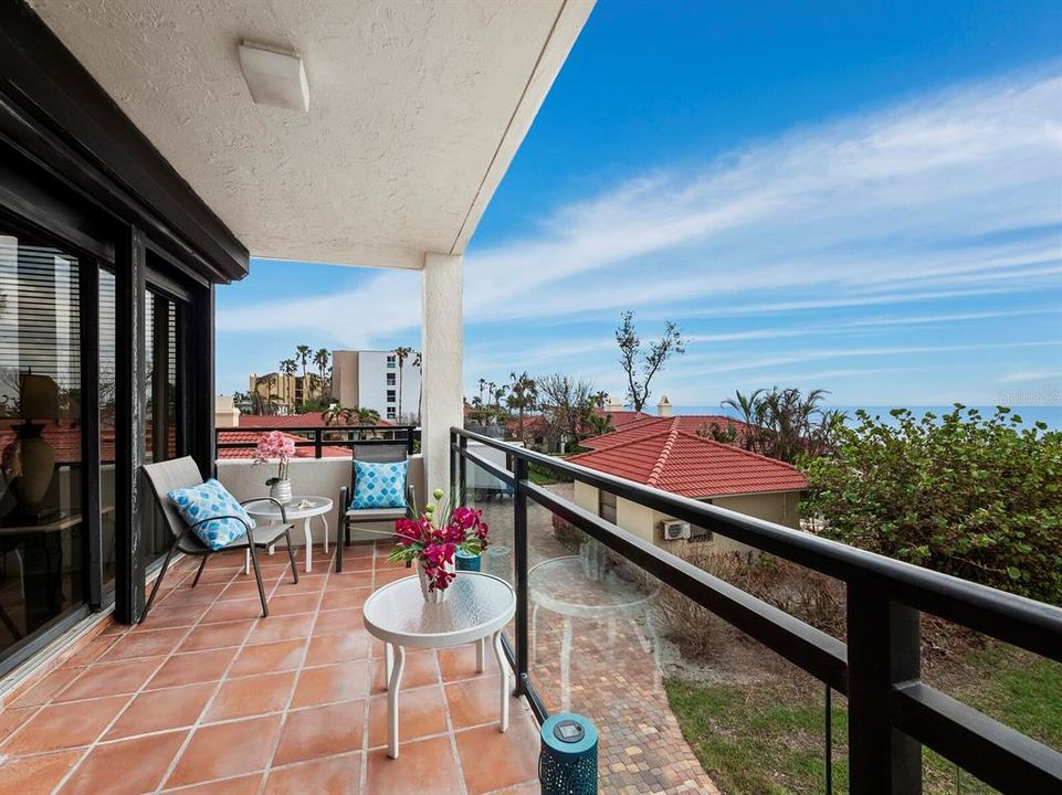 This spacious gulf-front balcony allows you and your guests to enjoy the outdoors under cover and the sliding glass doors are easily protected with built-in electric hurricane shutters.