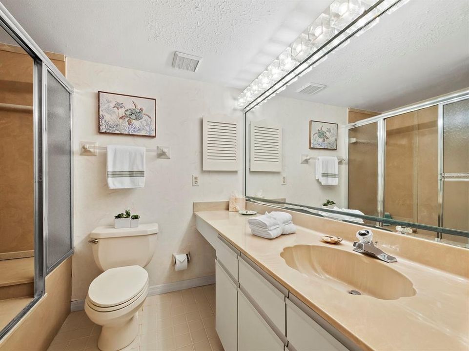 The Guest Bath offers an Enclosed Bathtub/Shower Combination, with ample vanity space.