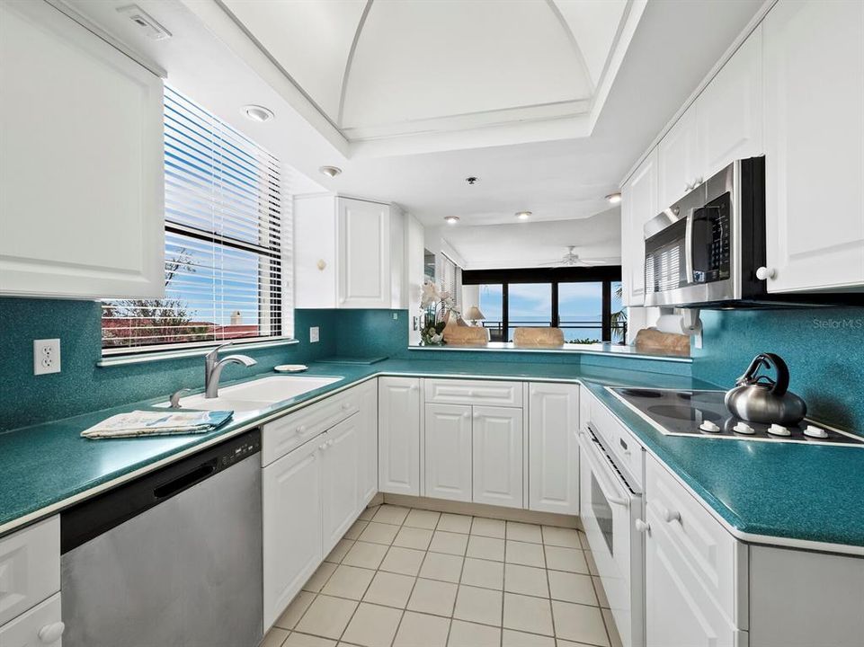 An abundance of Natural Light fills this kitchen with sufficient cabinet and countertop space.