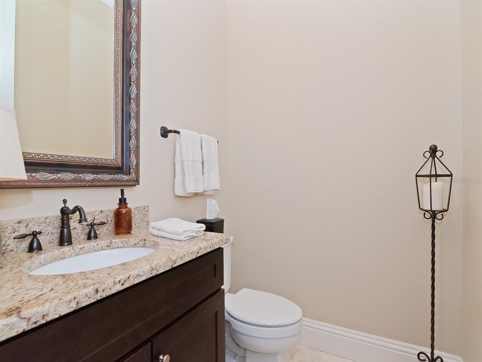 Powder room off foyer leaves other full bath on first floor for a private guest retreat.