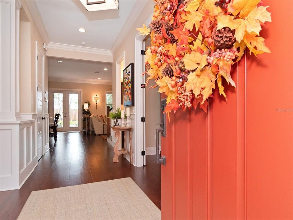 Wood floors, high ceilings, and crown moulding run throughout the home.