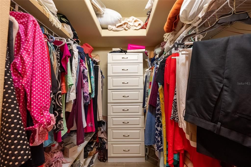 walk in closet with built in's in the primary bedroom