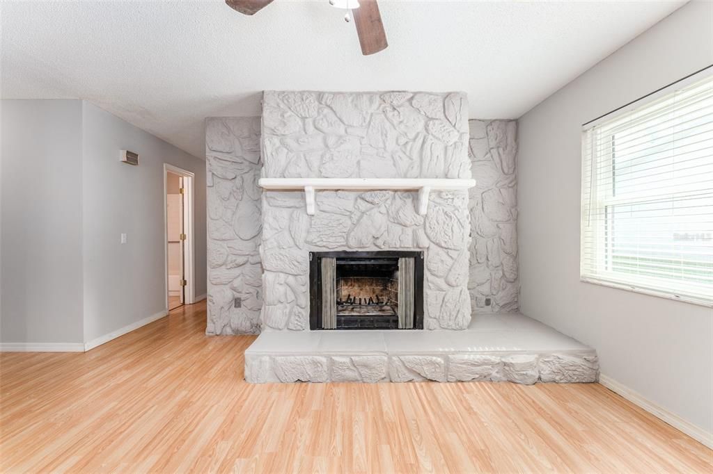 Decorative fireplace and hallway to bedrooms and bathrooms.